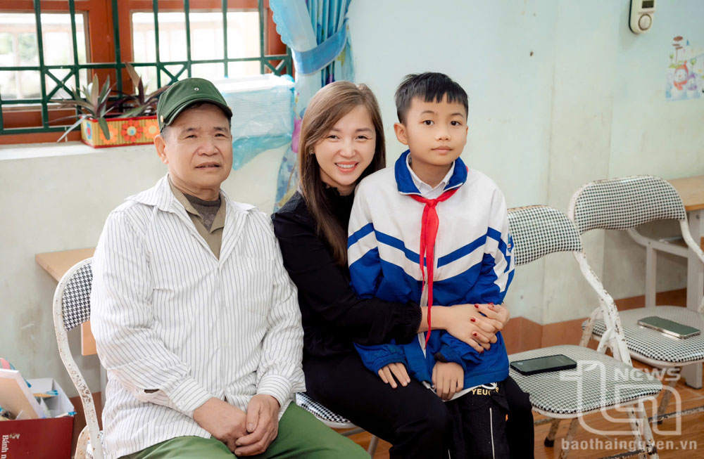 Chị Nguyễn Lê Mai bên người con nhận đỡ đầu.