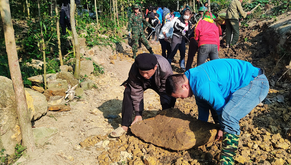 Các chiến sĩ cùng người dân địa phương san sửa tuyến đường đồi núi dài 600m.